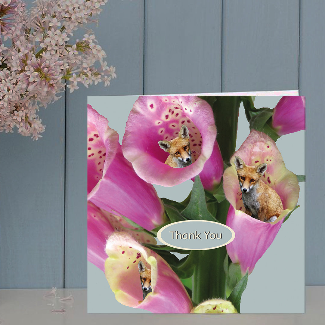 Greeting card with pink flowers and foxes .