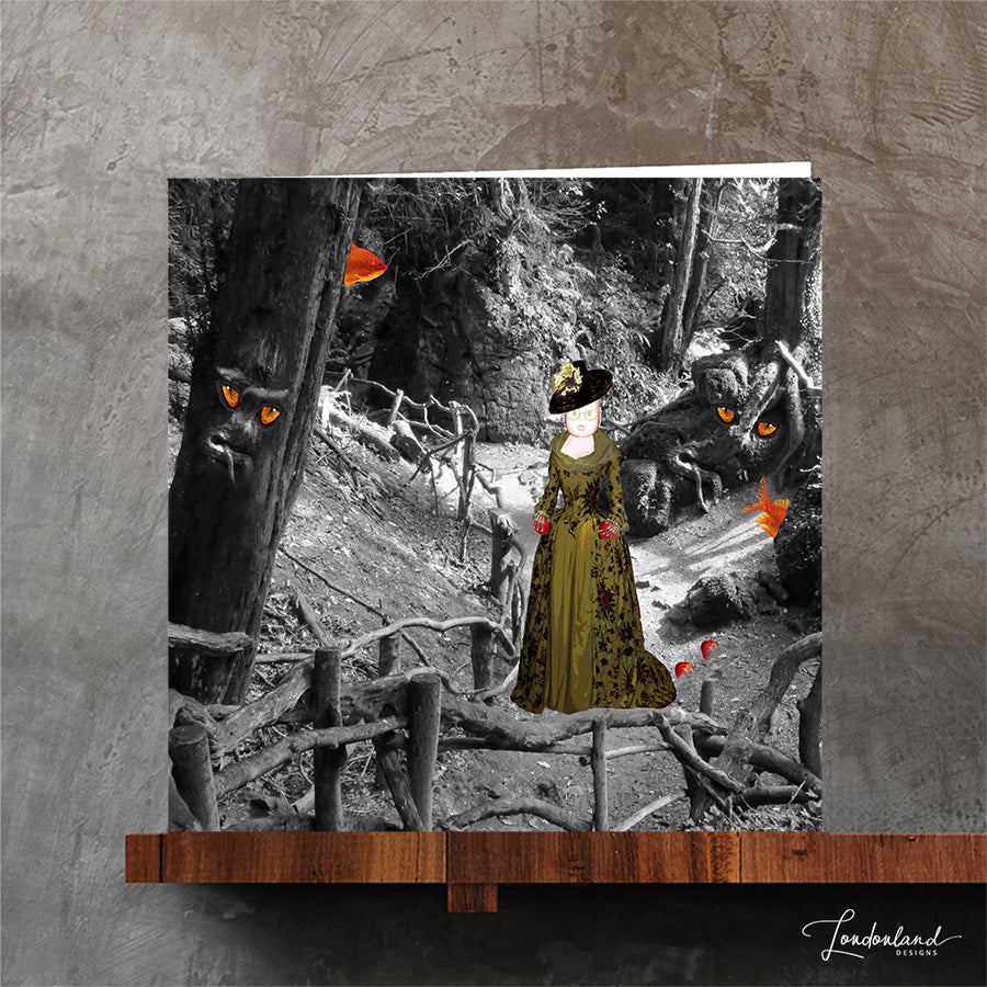 October halloween greeting card. The artwork shows a black and white forest scene with a woman in a long green dress standing near a tree, while tree figures with glowing orange eyes look toward her.