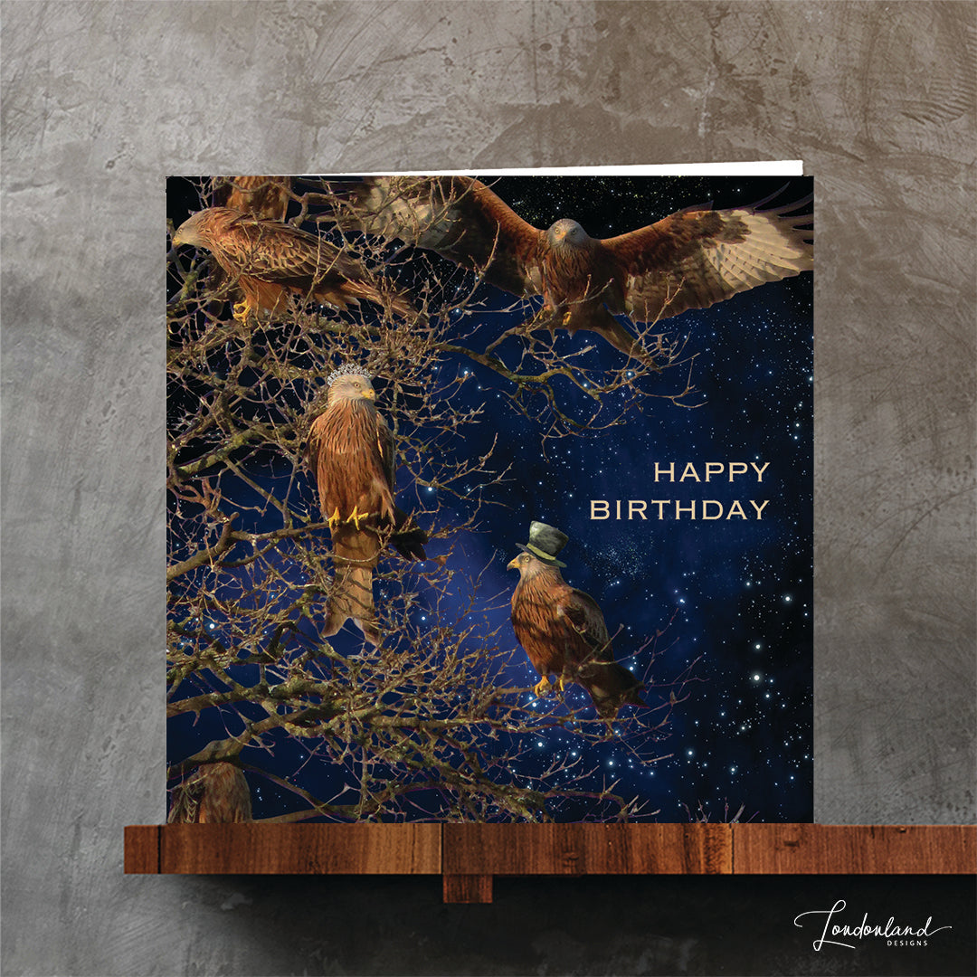 Kite birds wearing hat and tiara on tree branches with a starry sky. designer birthday card by Londonland Designs