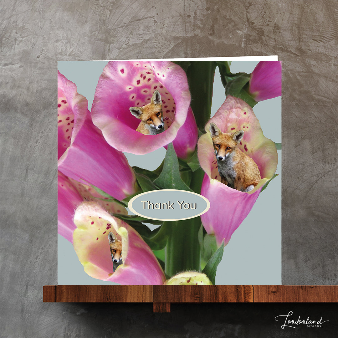 Card with pink flowers and foxes peeking out, featuring 'Thank You' text.