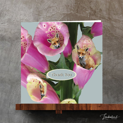 Card with pink flowers and foxes peeking out, featuring 'Thank You' text.