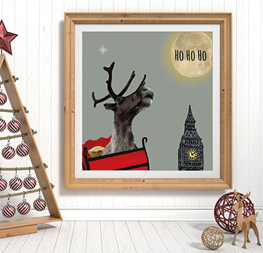 Framed artwork of a reindeer with Big Ben in the background on a white wall.