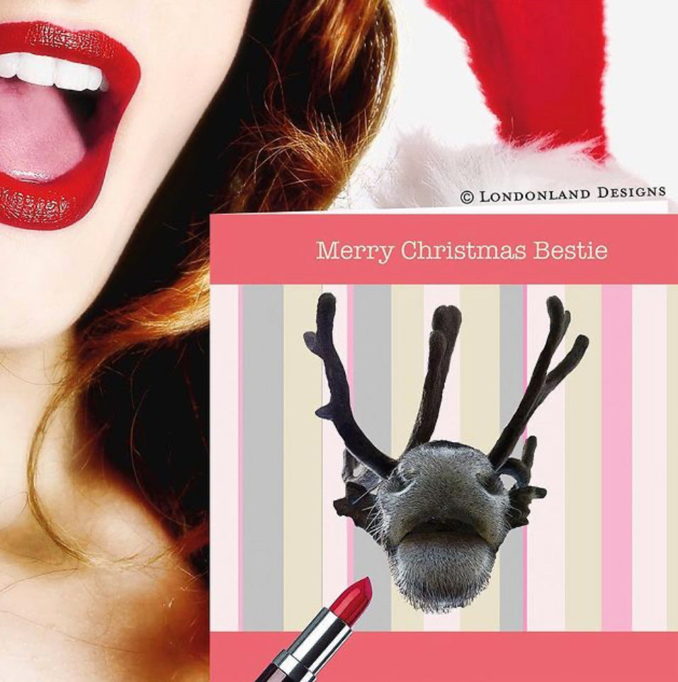 Close-up of a person with red lipstick and a reindeer decoration on a striped background with 'Merry Christmas Bestie' text.