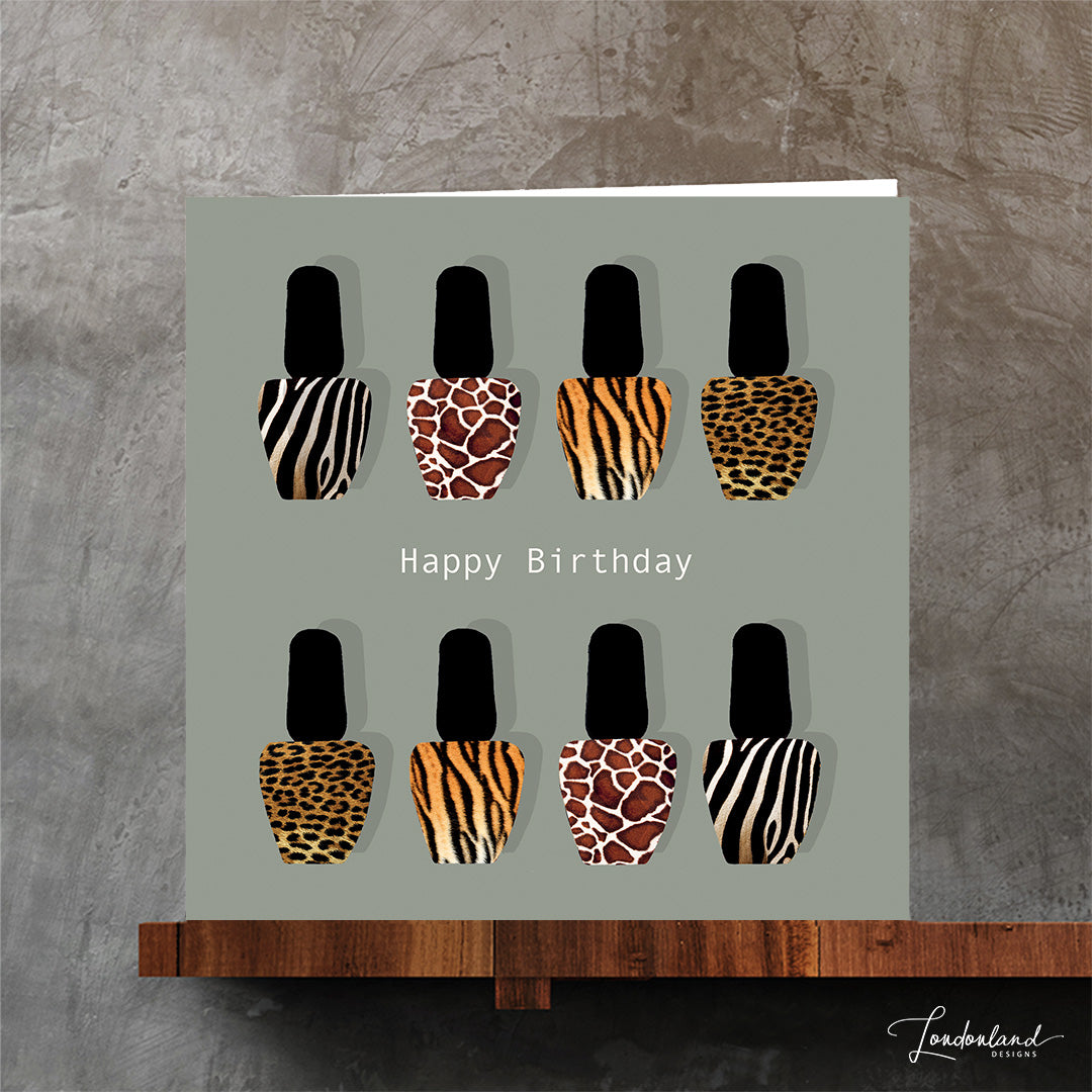 Original designer birthday card with giraffe, zebra, leopard and tiger animal print nail varnish bottles on a pale background.