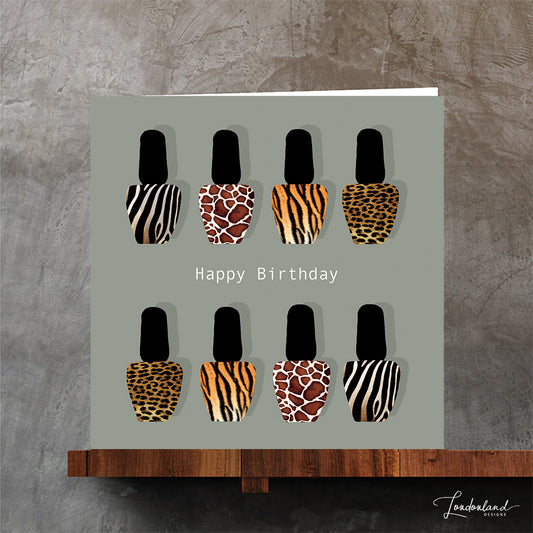 Original designer birthday card with giraffe, zebra, leopard and tiger animal print nail varnish bottles on a pale background.